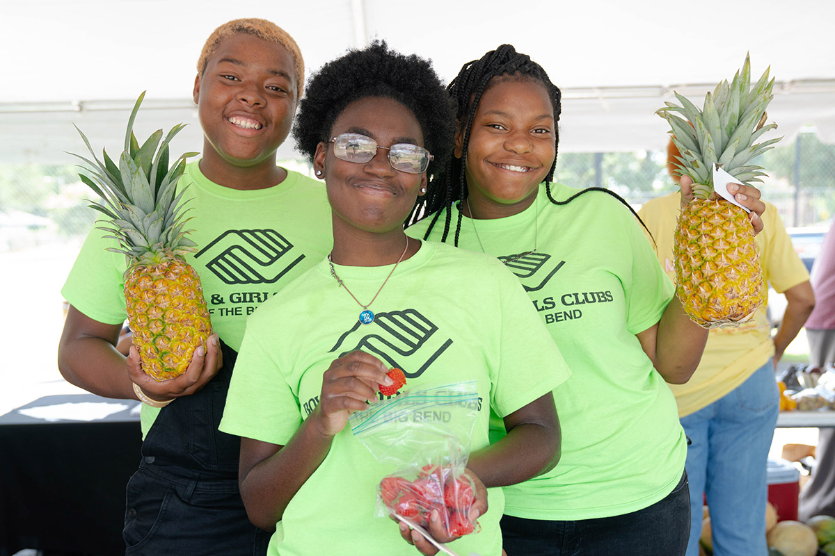 A group of kids with produce they procured.